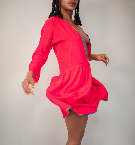 a woman in a pink dress posing for a picture